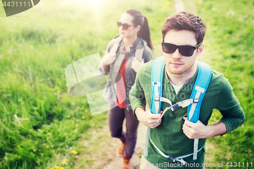 Image of couple with backpacks hiking outdoors