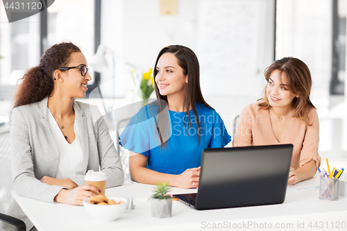 Image of businesswomen with laptop working at office