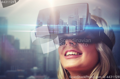Image of woman in virtual reality headset over city