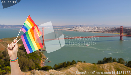 Image of hand with gay pride rainbow flags and wristband