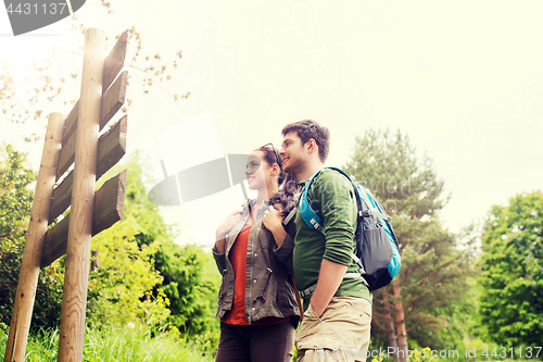 Image of smiling couple with backpacks hiking