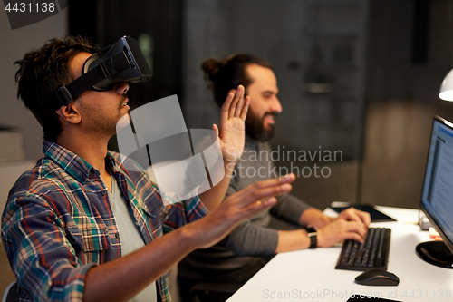 Image of creative man in virtual reality headset at office