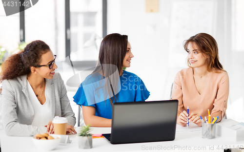Image of businesswomen with laptop working at office