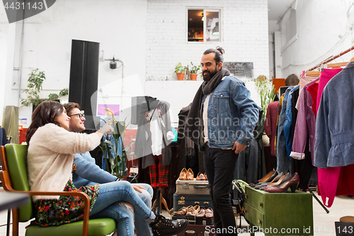 Image of friends choosing clothes at vintage clothing store