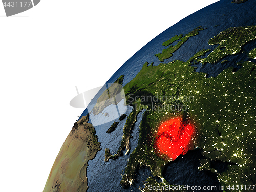 Image of Romania in red on Earth at night