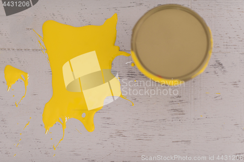 Image of Yellow paint tin can