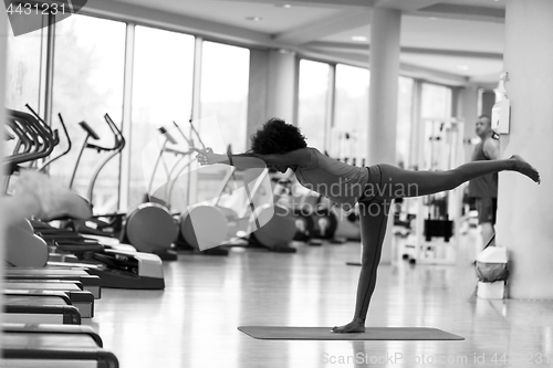 Image of african american woman exercise yoga in gym