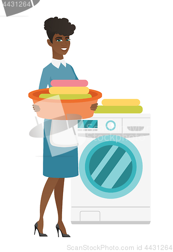 Image of Housewife using washing machine at laundry.