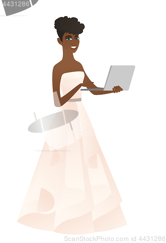 Image of African bride in a white dress using a laptop.