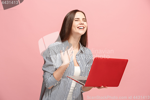 Image of Businesswoman with laptop on pink studio