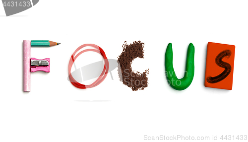 Image of The word focus created from office stationery.