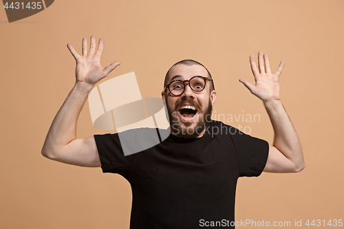 Image of Winning success man happy ecstatic celebrating being a winner. Dynamic energetic image of male model