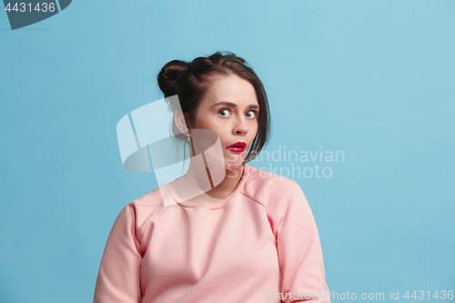 Image of Beautiful woman looking suprised isolated on blue