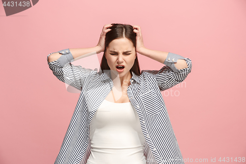 Image of Woman having headache. Isolated over pastel background.