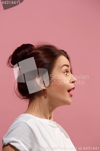 Image of Beautiful woman looking suprised isolated on pink