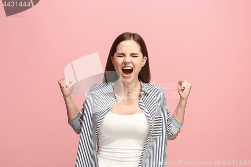 Image of The young emotional angry woman screaming on pink studio background