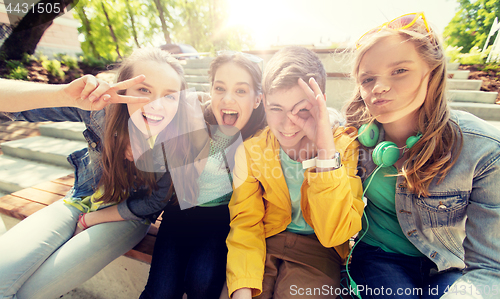 Image of happy teenage students or friends having fun