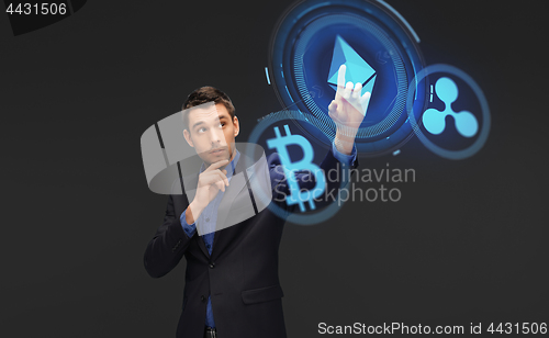 Image of businessman with cryptocurrency holograms