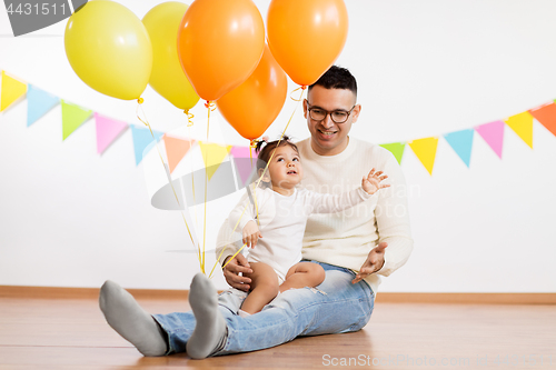 Image of father and daughter with birthday party balloons