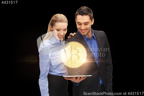 Image of businesspeople with tablet pc and bitcoin hologram