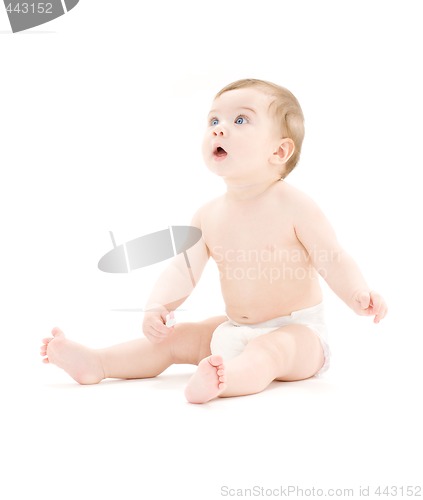 Image of baby boy in diaper with toothbrush