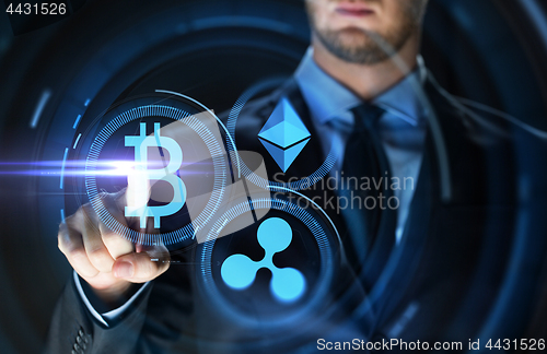 Image of businessman with at cryptocurrency icons