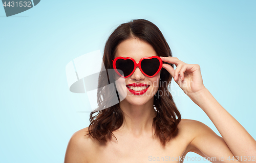 Image of woman with red lipstick and heart shaped shades