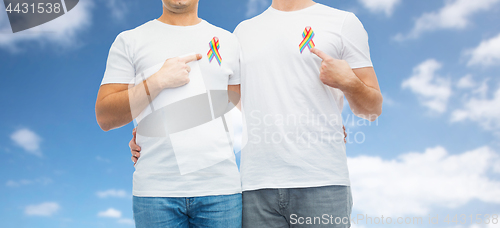 Image of close up of couple with gay pride rainbow ribbons