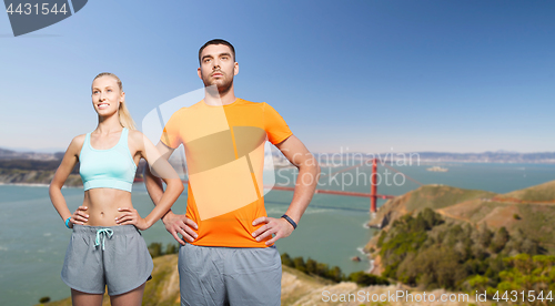 Image of happy couple doing sports over golden gate bridge