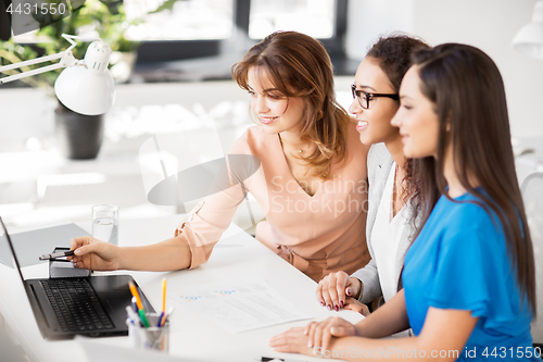 Image of businesswomen with laptop working at office