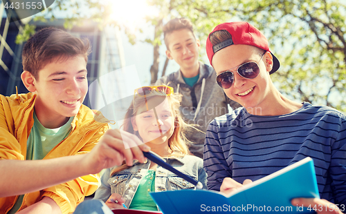 Image of group of students with notebooks at school yard