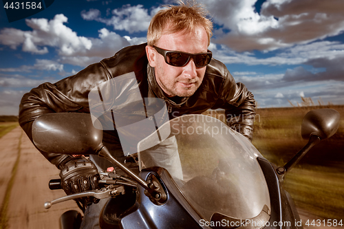 Image of Biker racing on the road