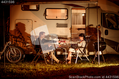 Image of Adult couple clinking glasses of wine. Family vacation travel RV