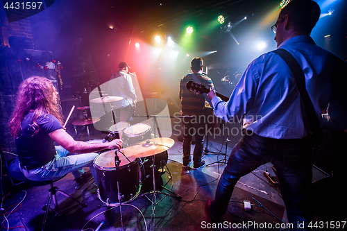 Image of Band performs on stage in a nightclub