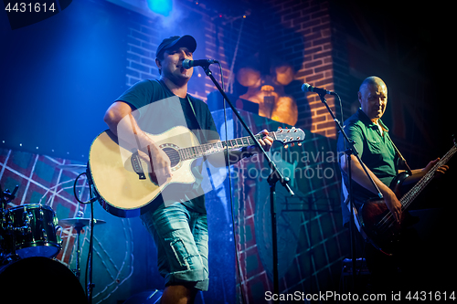 Image of Band performs on stage in a nightclub