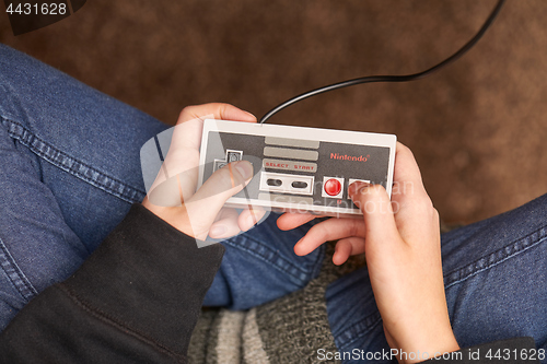 Image of Nintengo NES,playing Super Mario 3