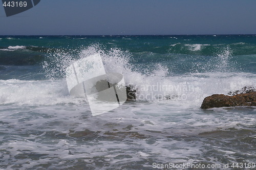 Image of Waves beating rocks on greek island