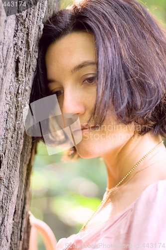 Image of unhappy woman near the tree