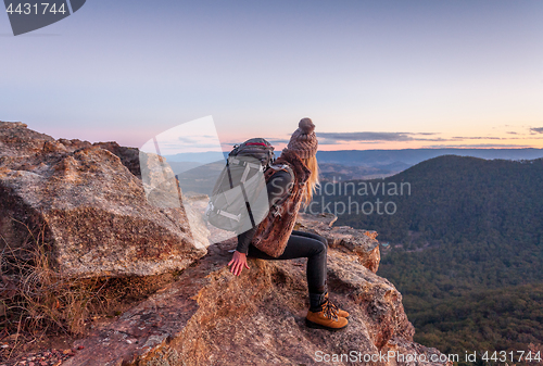 Image of Female with backpack on mountain peak Blue Mountains