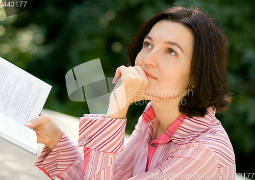 Image of woman reading in park