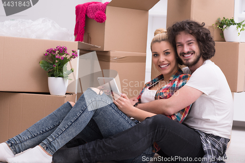 Image of young couple moving  in new house