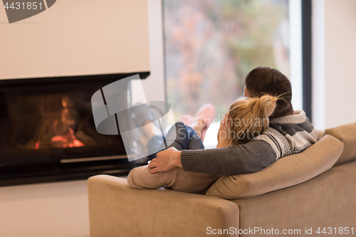 Image of Young couple  in front of fireplace