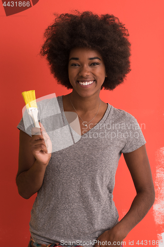 Image of black woman painting wall