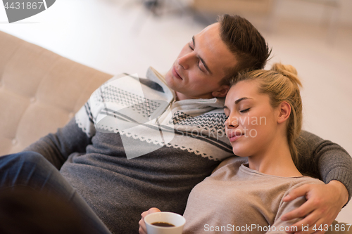 Image of Young couple  in front of fireplace