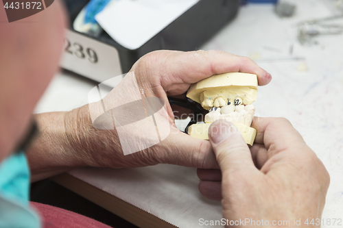 Image of Dental Technician Working On 3D Printed Mold For Tooth Implants