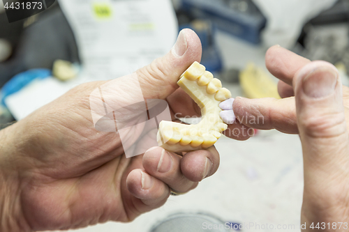 Image of Dental Technician Working On 3D Printed Mold For Tooth Implants