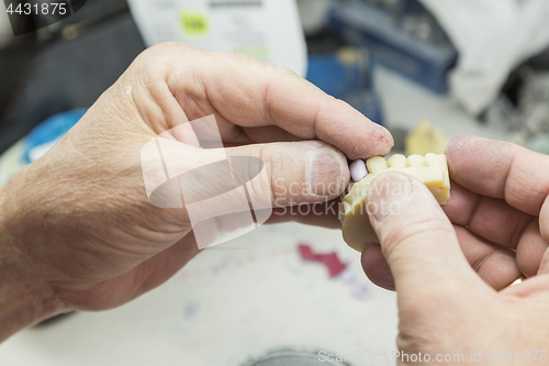 Image of Dental Technician Working On 3D Printed Mold For Tooth Implants