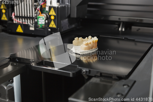 Image of 3D Printer With Finished 3D Printed Dental Implant Bridge