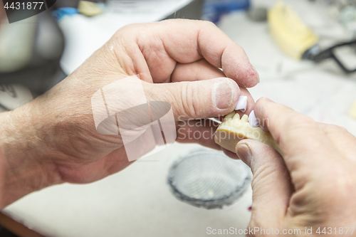 Image of Dental Technician Working On 3D Printed Mold For Tooth Implants