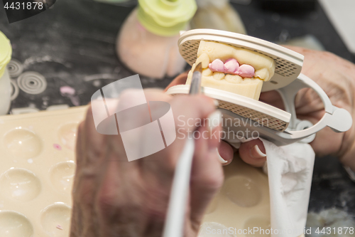 Image of Dental Technician Applying Porcelain To 3D Printed Implant Mold
